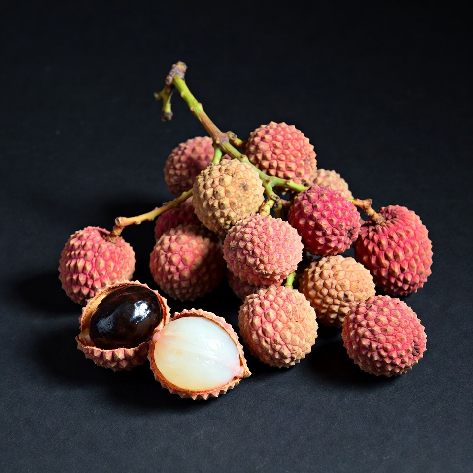 Fresh Lychee Fruits on Black Background Fresh Lychee Fruits on Black Background