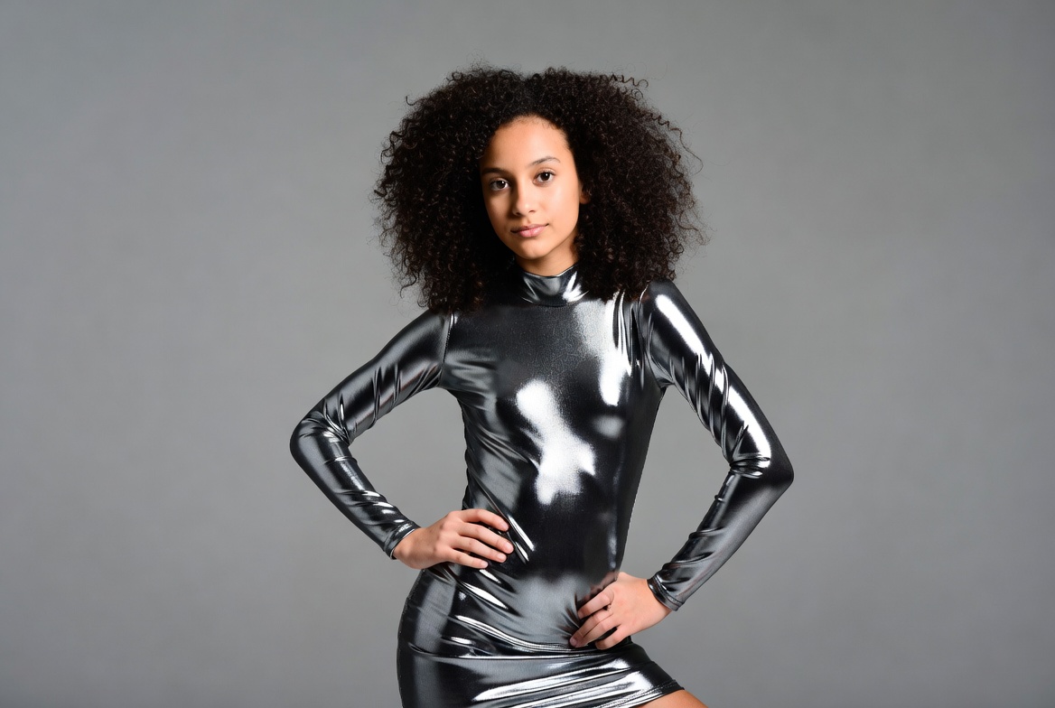 Young Black woman in shiny silver dress Young Black woman in shiny silver dress