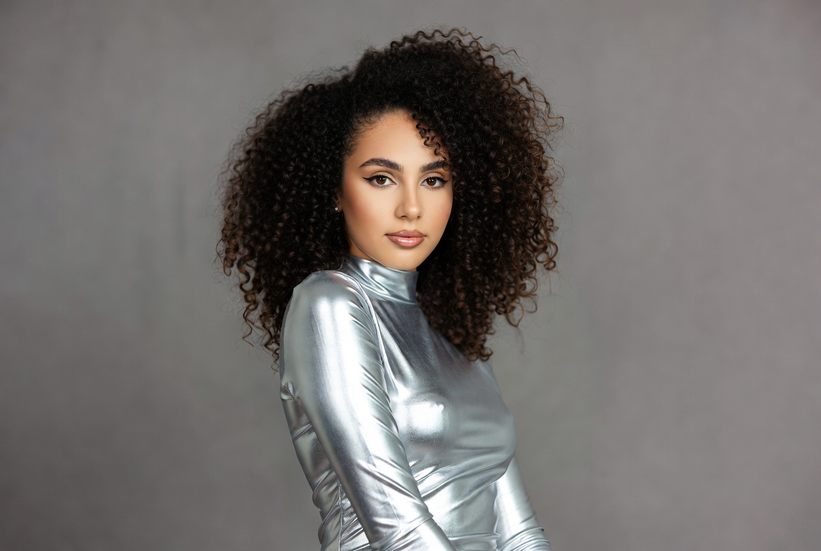 Woman in silver turtleneck with curly hair Woman in silver turtleneck with curly hair