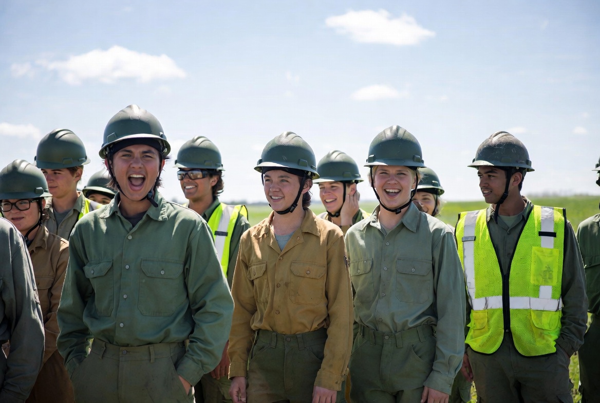 Group of young people in helmets and vests Group of young people in helmets and vests