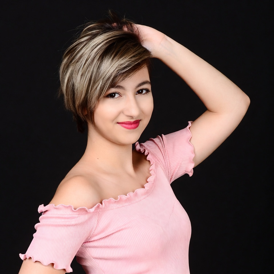 Woman with short hair hand on head Woman with short hair hand on head