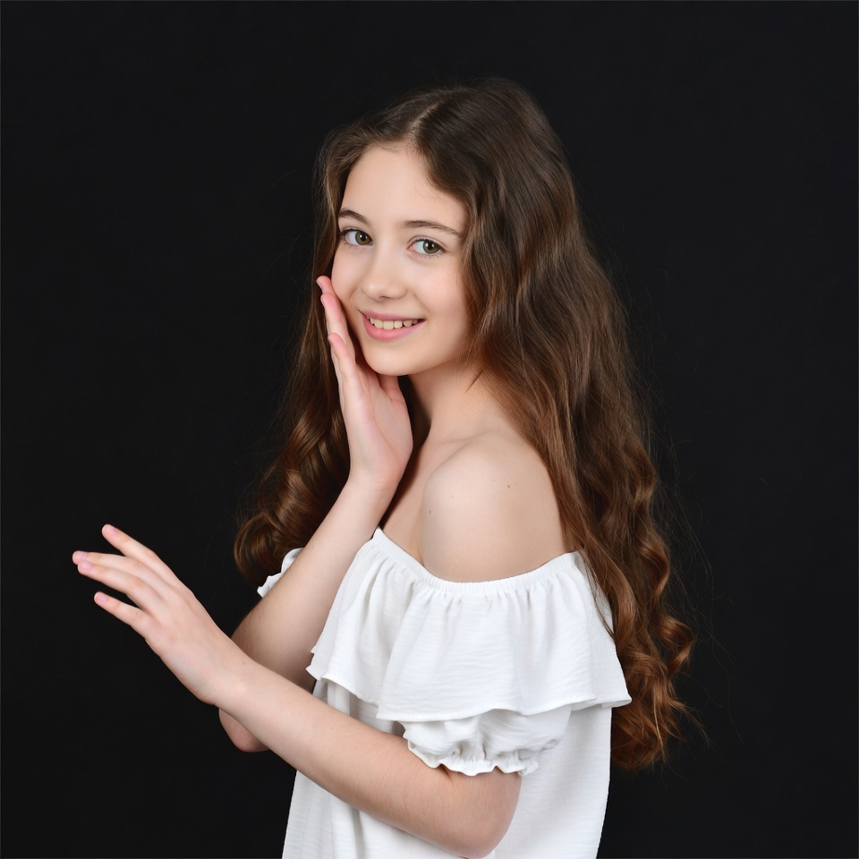 Smiling girl touching cheek off-shoulder top Smiling girl touching cheek off-shoulder top