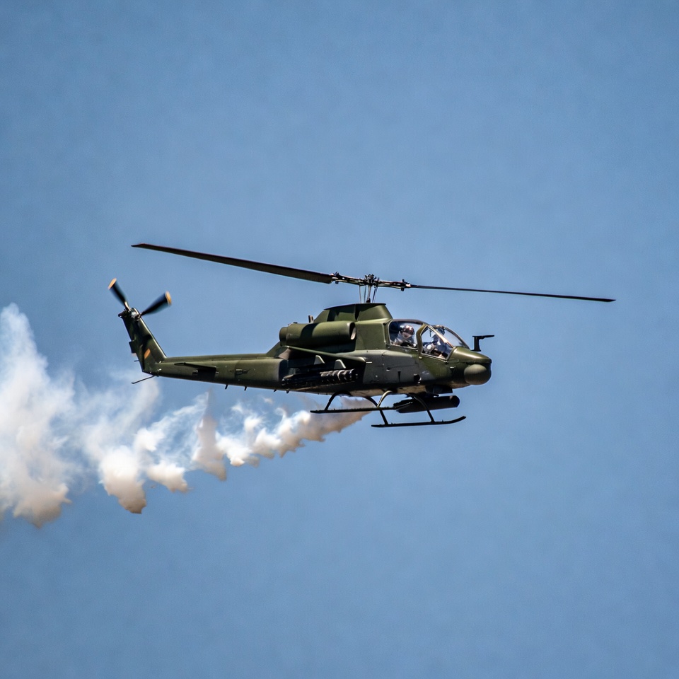 Military helicopter flying with smoke trail Military helicopter flying with smoke trail