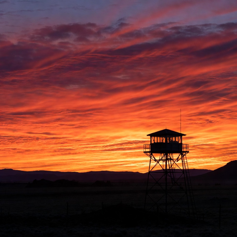 Watchtower silhouetted against sunset Watchtower silhouetted against sunset