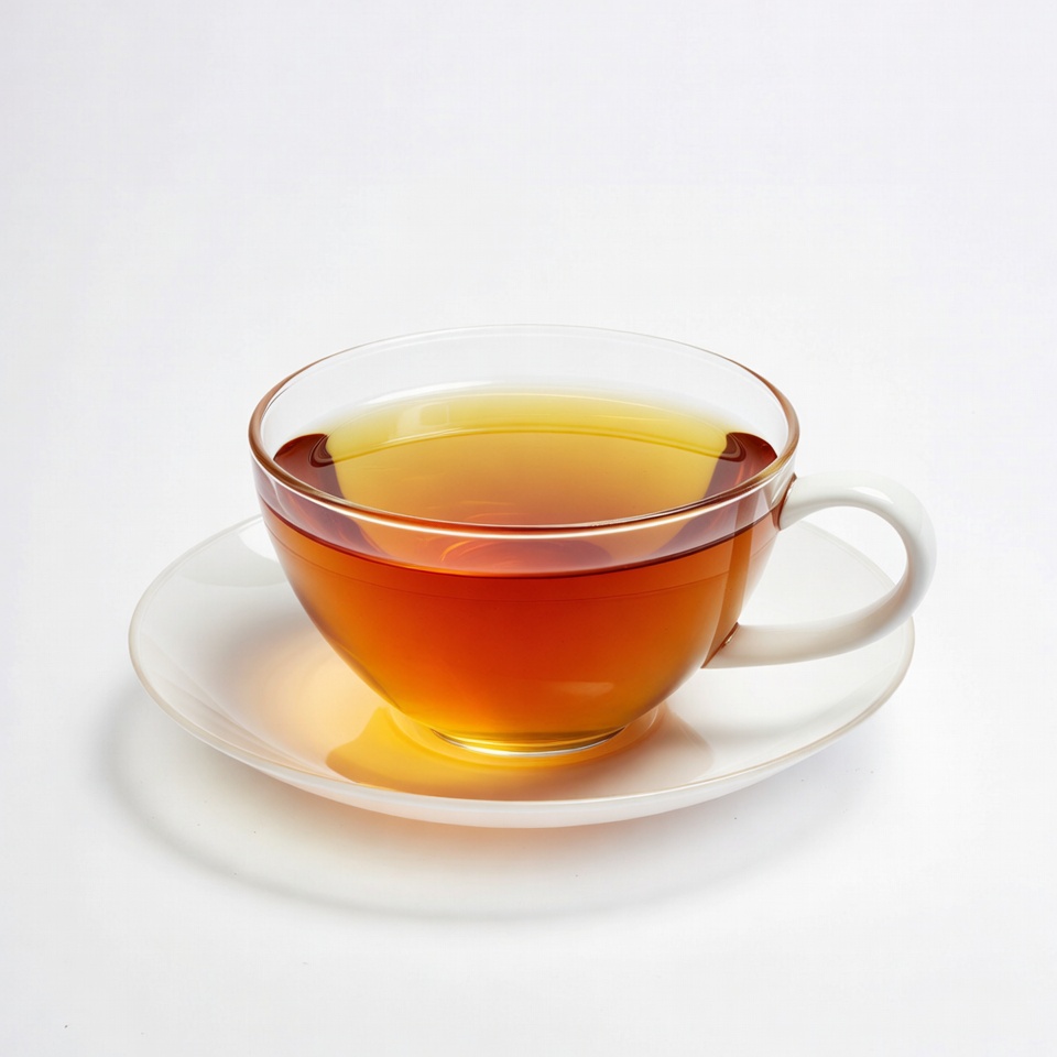 Glass cup of tea on saucer Glass cup of tea on saucer