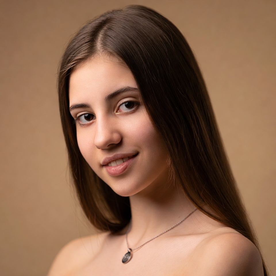 Young woman with long brown hair smiling Young woman with long brown hair smiling