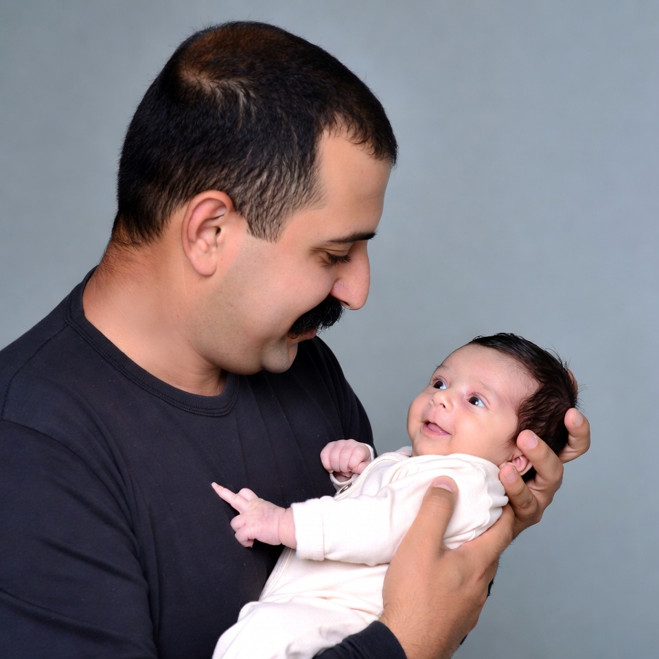 Father holding smiling baby Father holding smiling baby