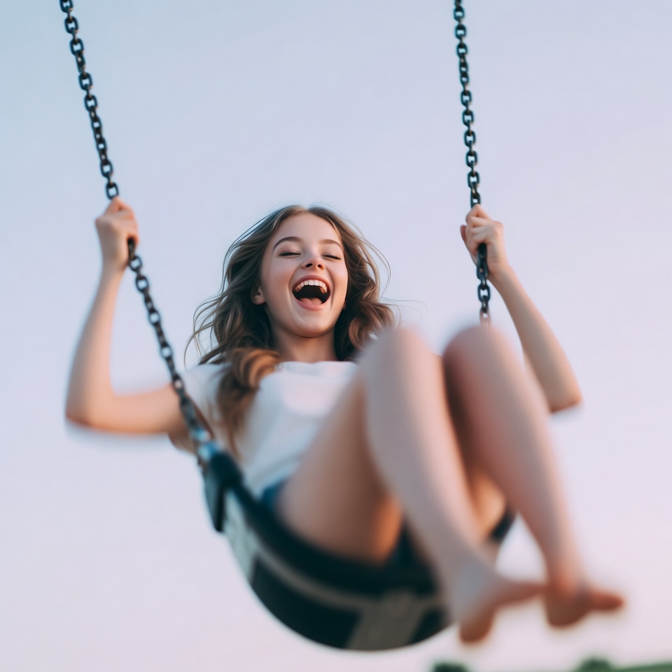 Girl swinging on playground swing Girl swinging on playground swing