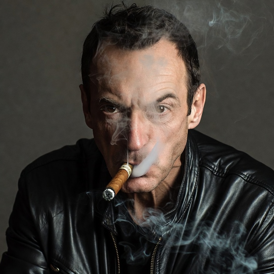 Man smoking cigar in leather jacket Man smoking cigar in leather jacket