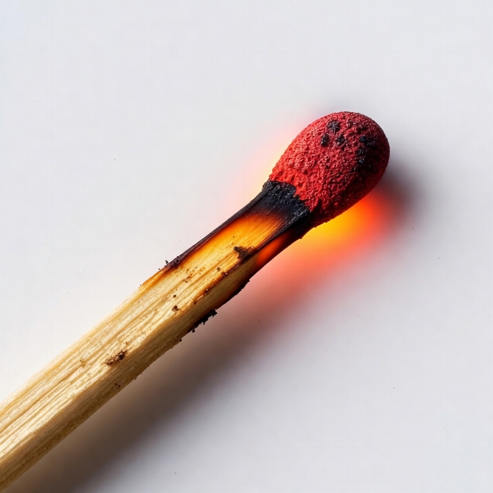 Burning Matchstick on White Background Burning Matchstick on White Background
