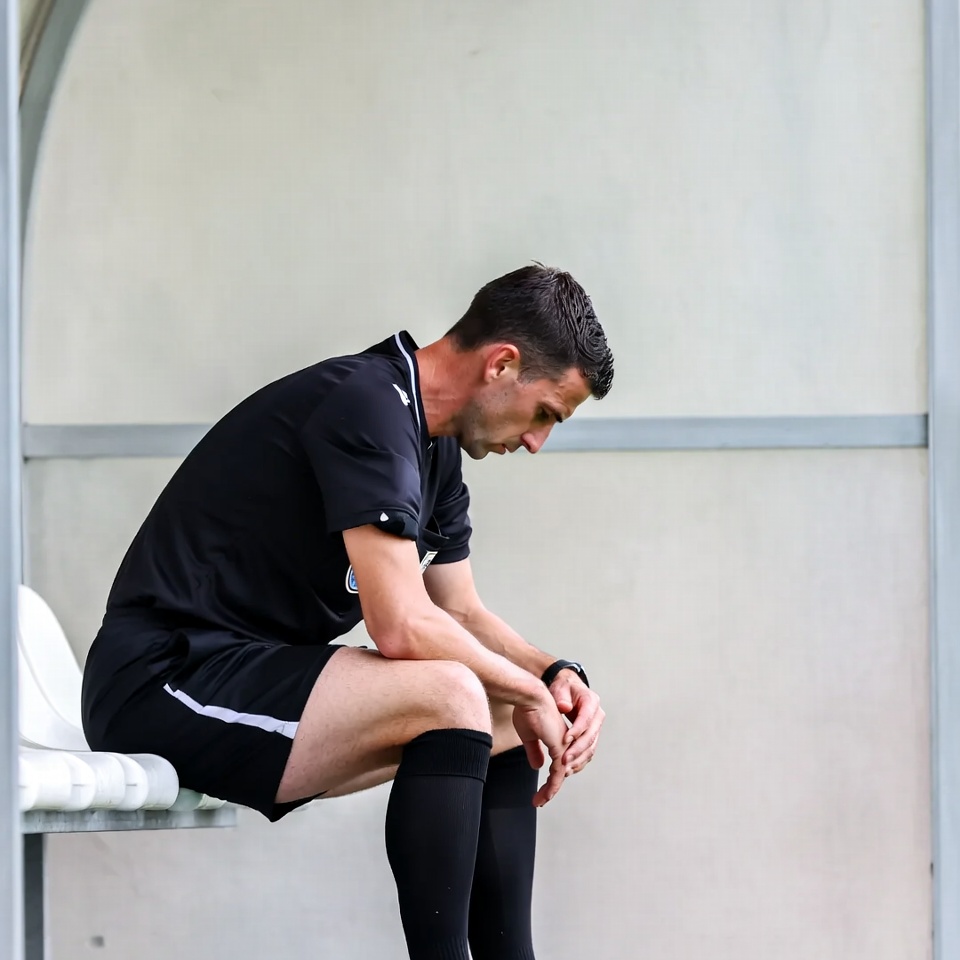 Soccer referee sitting pensively Soccer referee sitting pensively