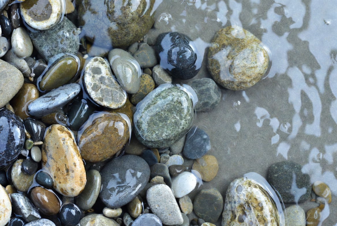 Wet colorful pebbles on beach Wet colorful pebbles on beach