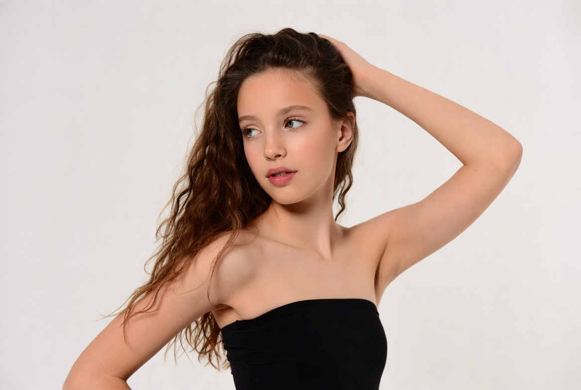 Teen girl with wavy hair hand on head Teen girl with wavy hair hand on head