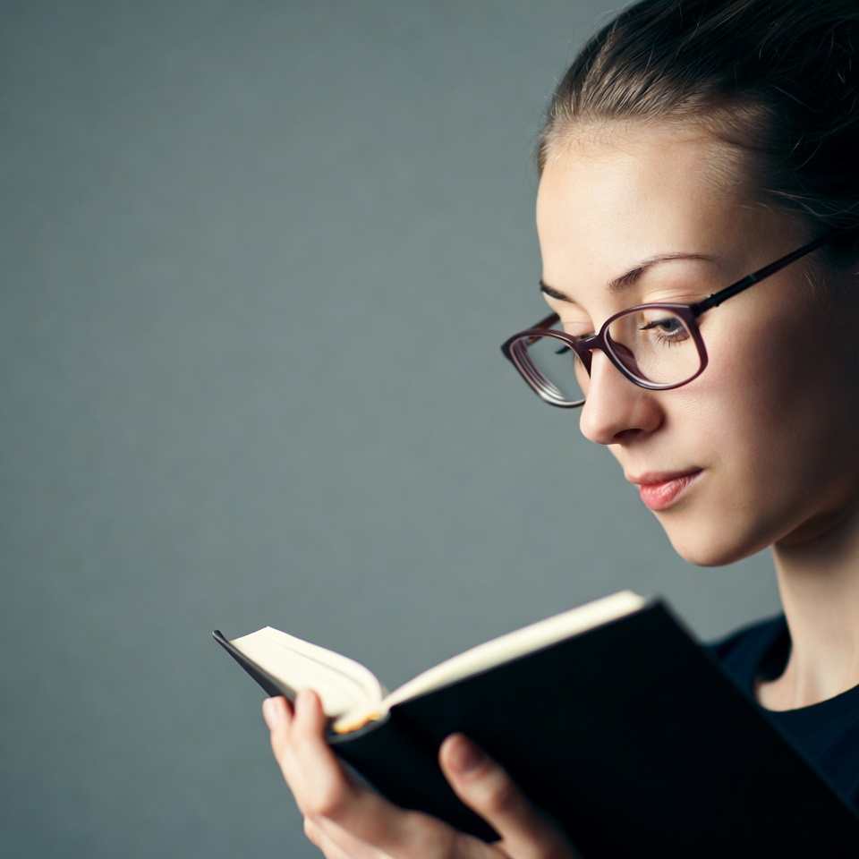 Woman reading book with glasses Woman reading book with glasses