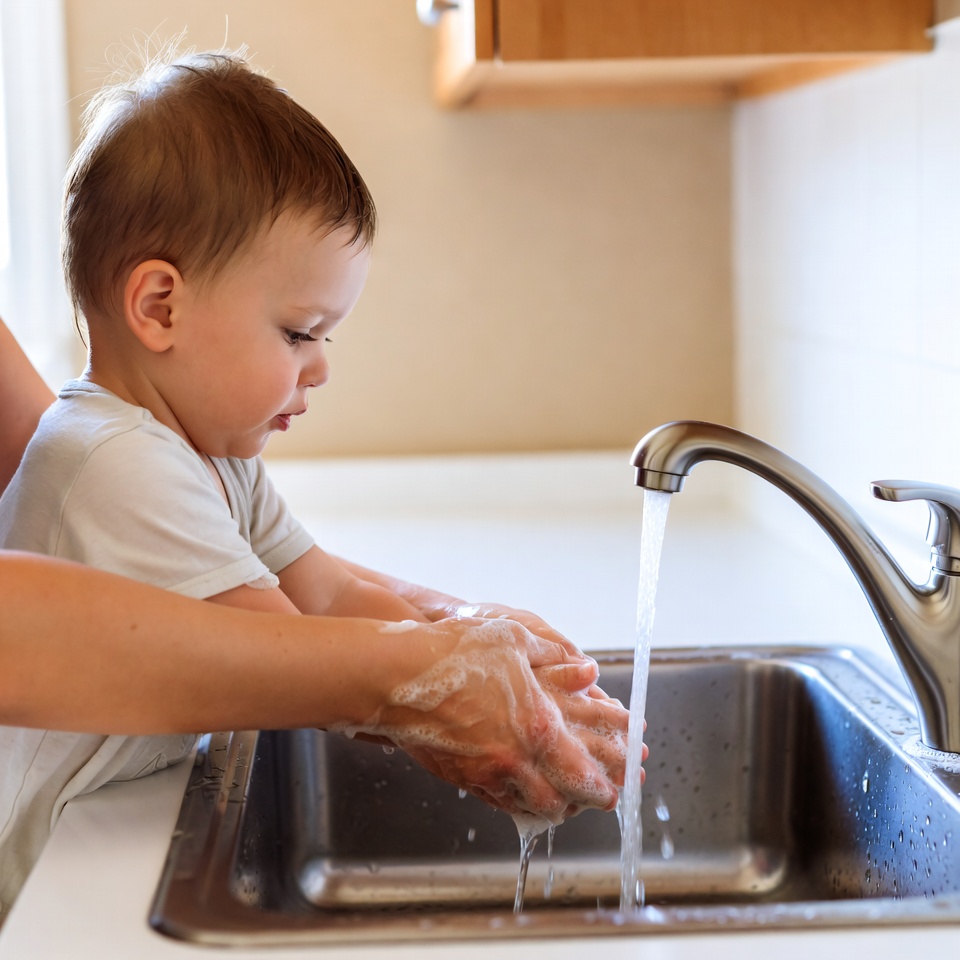 Toddler washing hands with mom Toddler washing hands with mom
