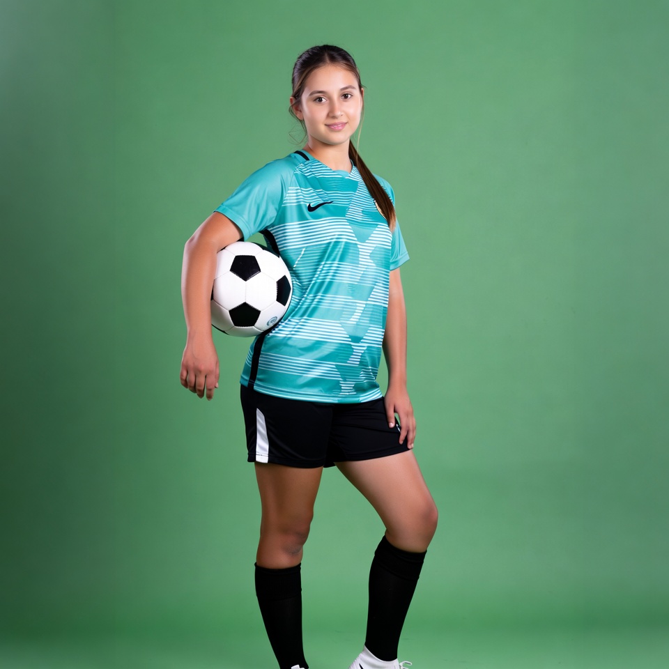 Girl holding soccer ball in uniform Girl holding soccer ball in uniform