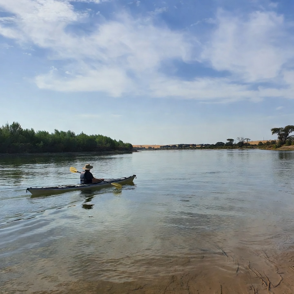 Man kayaking on river Man kayaking on river