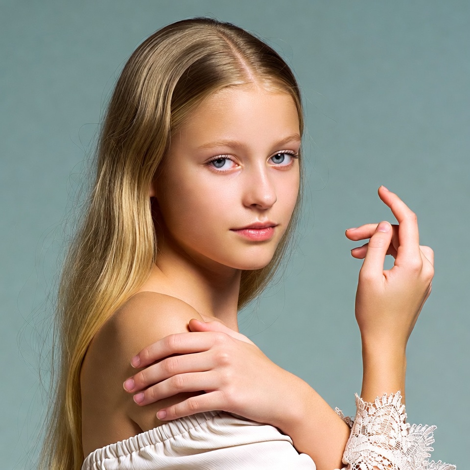 Blonde girl posing on blue background Blonde girl posing on blue background