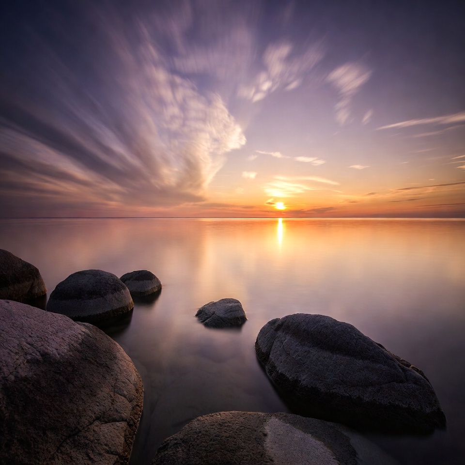 Sunset over calm lake with rocks Sunset over calm lake with rocks