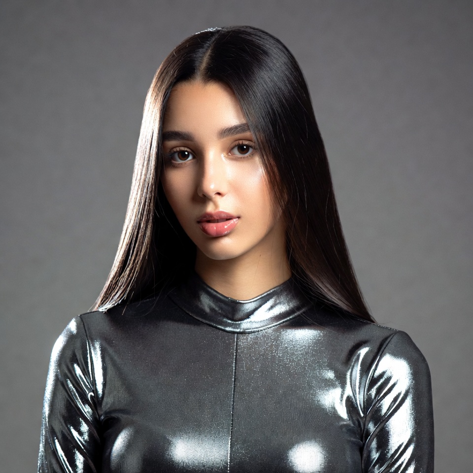 Woman in shiny silver turtleneck Woman in shiny silver turtleneck