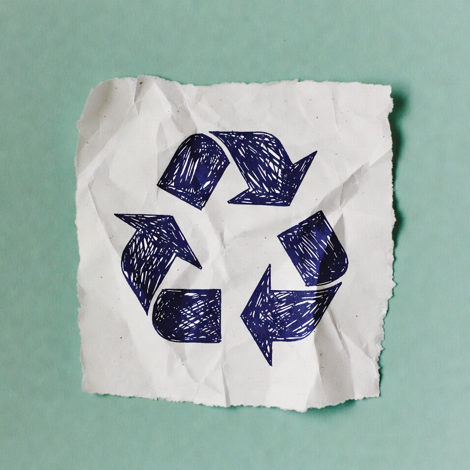 Hand-drawn recycle symbol on crumpled paper Hand-drawn recycle symbol on crumpled paper