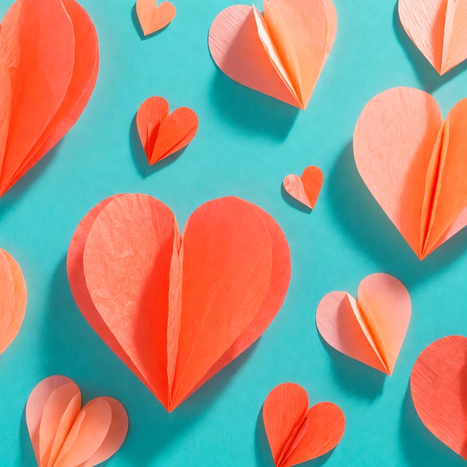 Orange paper hearts on blue background Orange paper hearts on blue background