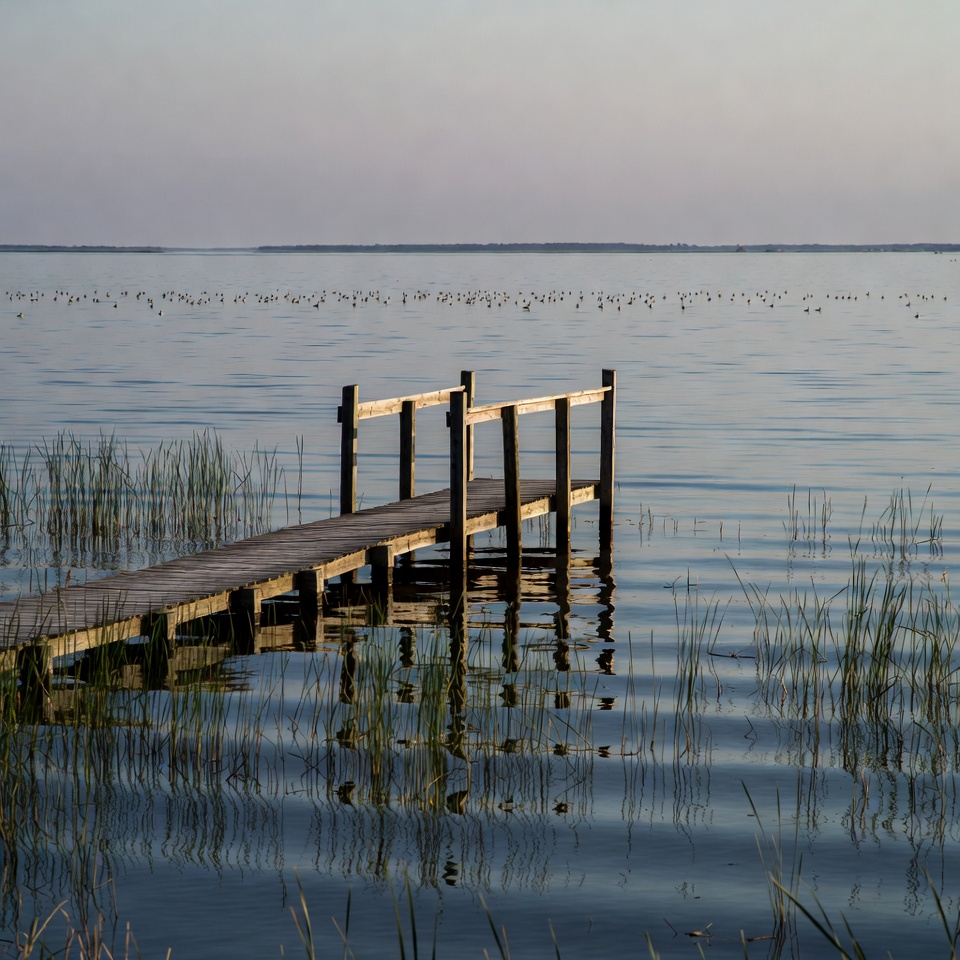 Wooden pier extending into lake Wooden pier extending into lake