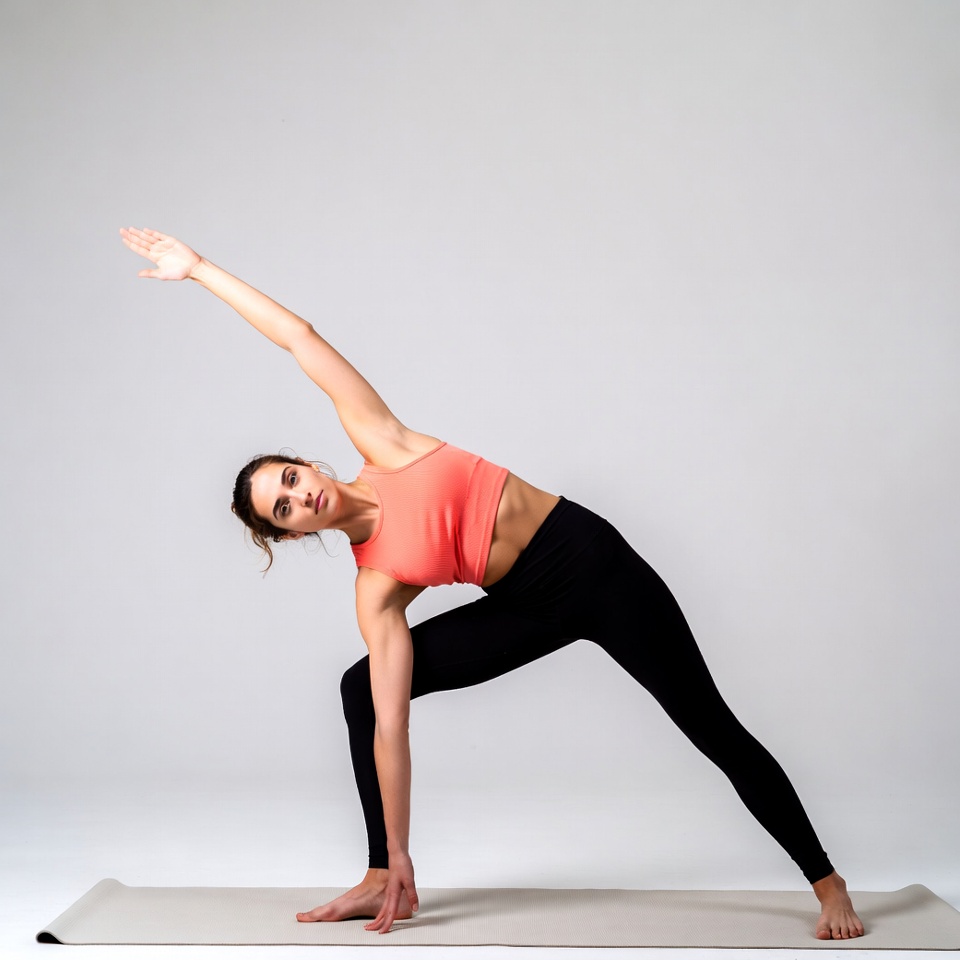 Woman doing extended side angle yoga pose Woman doing extended side angle yoga pose