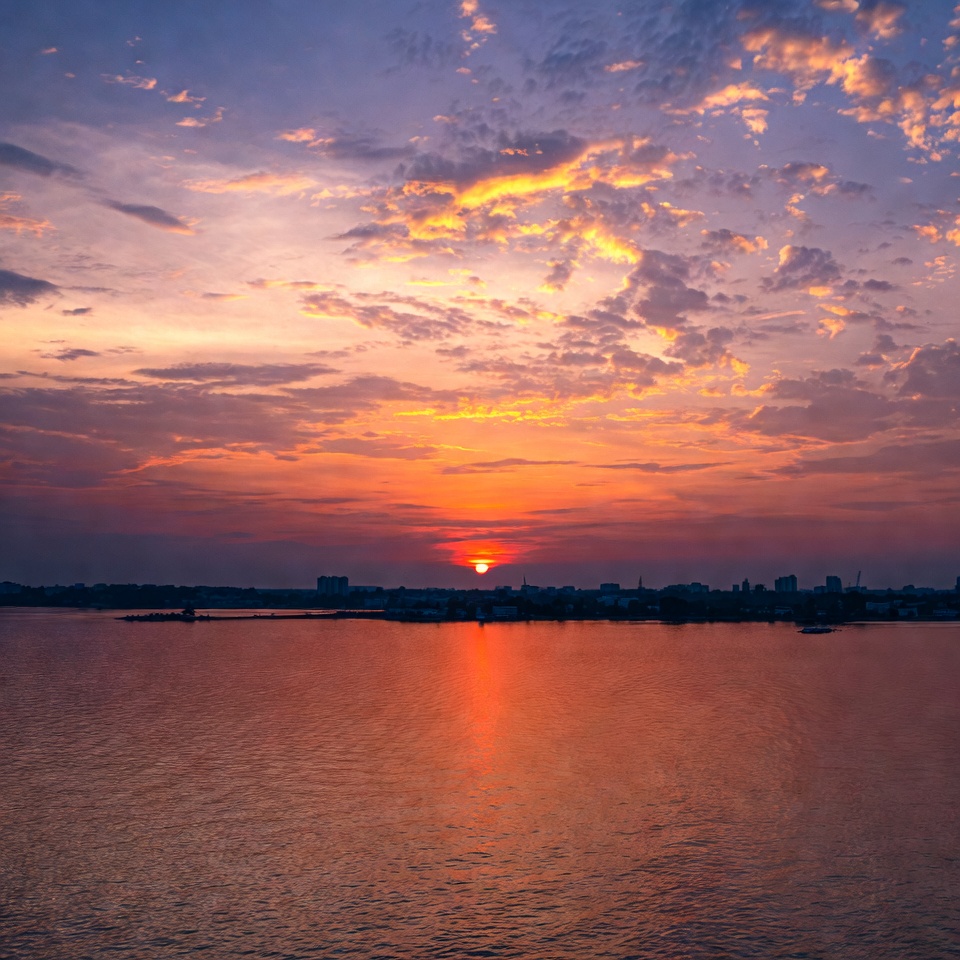 Sunset over lake with city skyline Sunset over lake with city skyline
