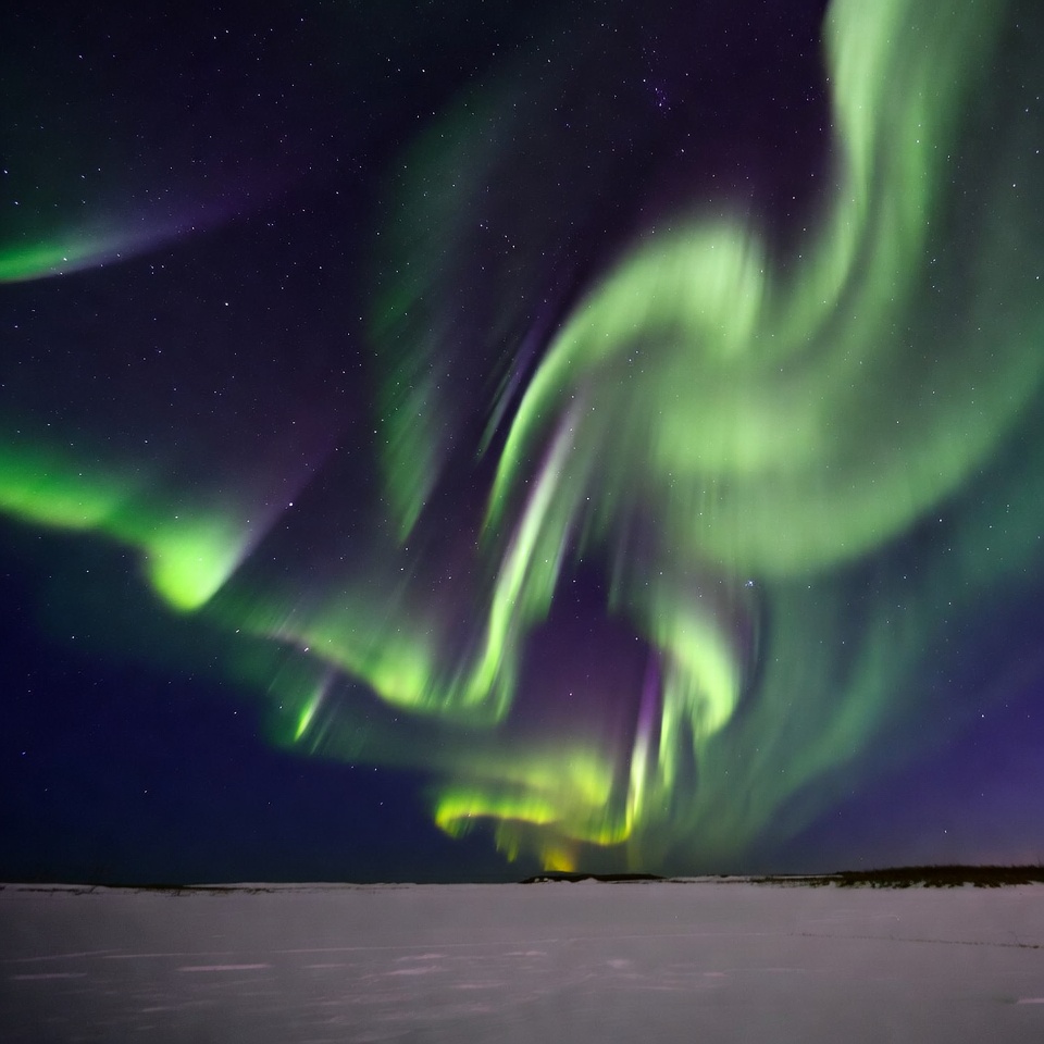 Vibrant Northern Lights over Snowy Landscape Vibrant Northern Lights over Snowy Landscape