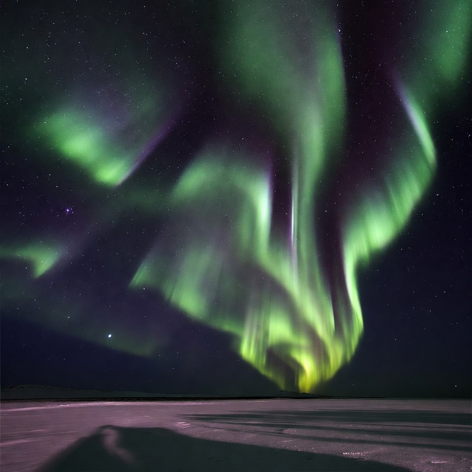 Vibrant Northern Lights over Snowy Landscape Vibrant Northern Lights over Snowy Landscape