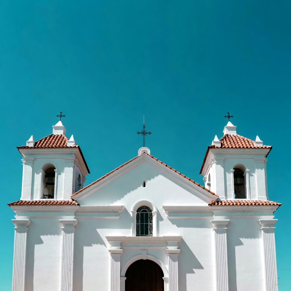 White colonial church with twin bell towers White colonial church with twin bell towers