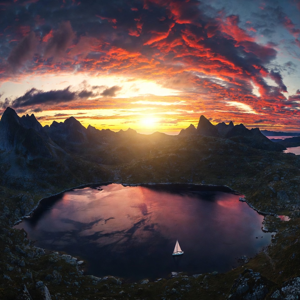 Sailboat on lake amid sunset mountains Sailboat on lake amid sunset mountains