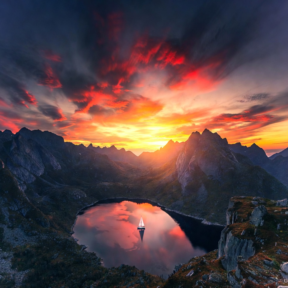 Sailboat on lake amid sunset mountains Sailboat on lake amid sunset mountains