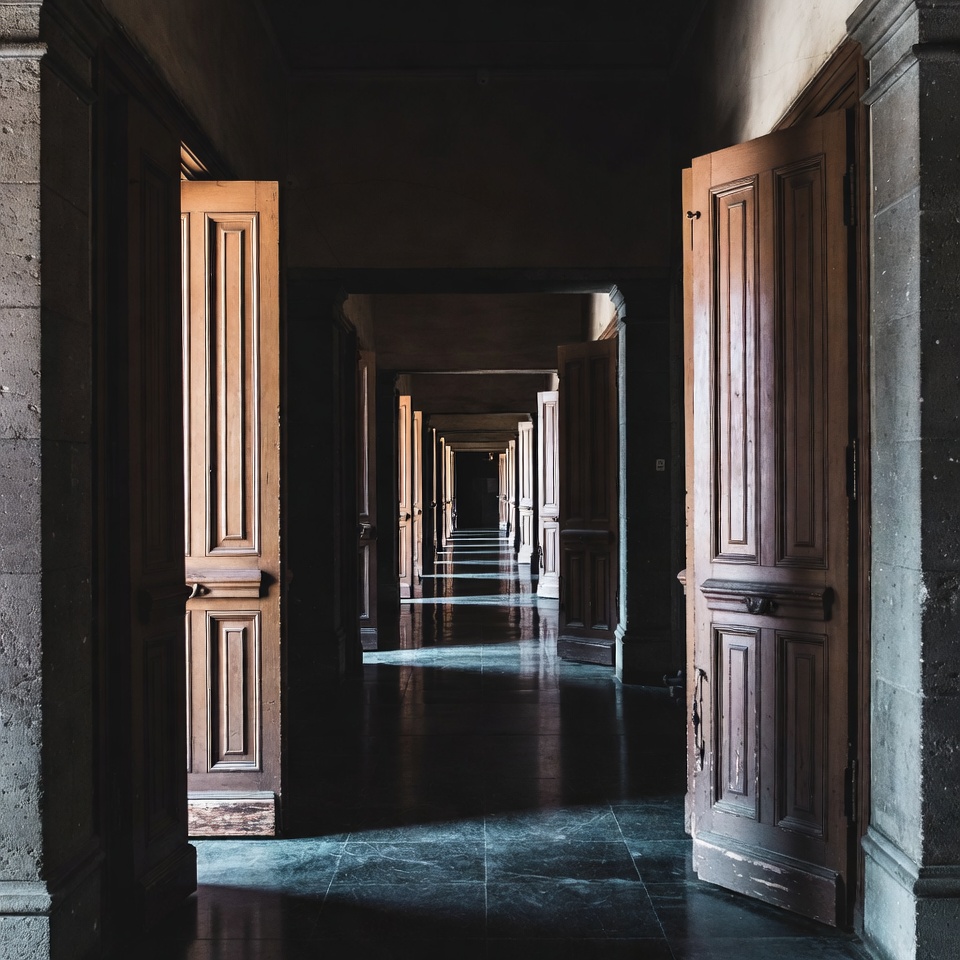 Long Hallway with Open Wooden Doors Long Hallway with Open Wooden Doors