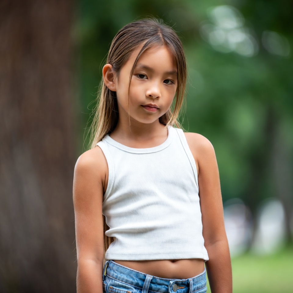 Asian girl in white tank top outdoors Asian girl in white tank top outdoors