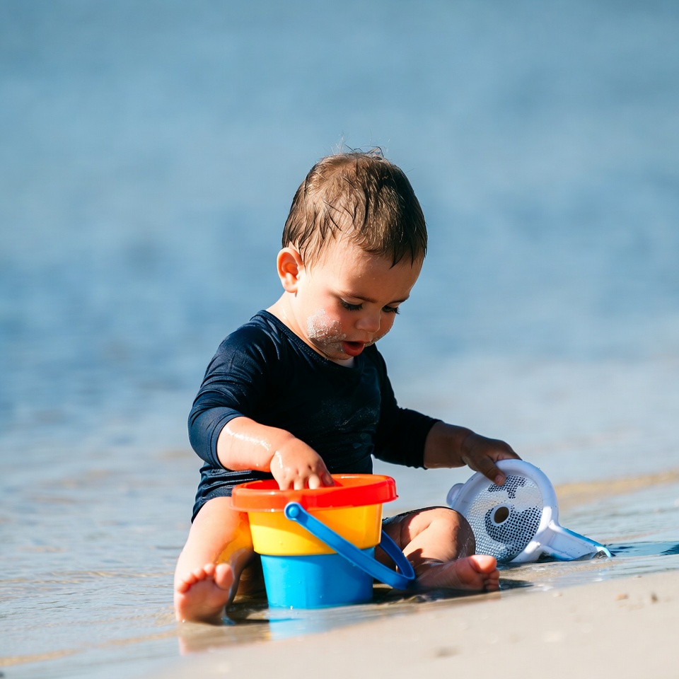 Baby playing with beach toys Baby playing with beach toys