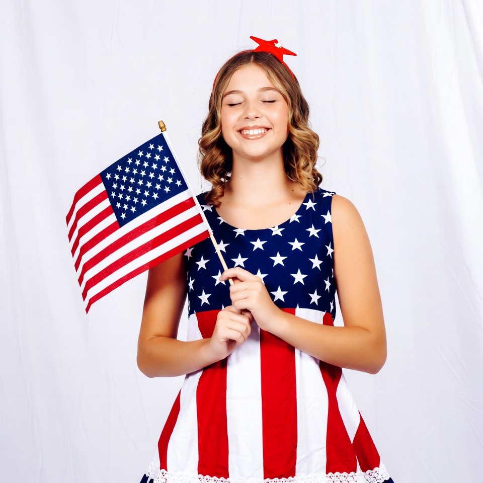 Girl holding American flag smiling Girl holding American flag smiling