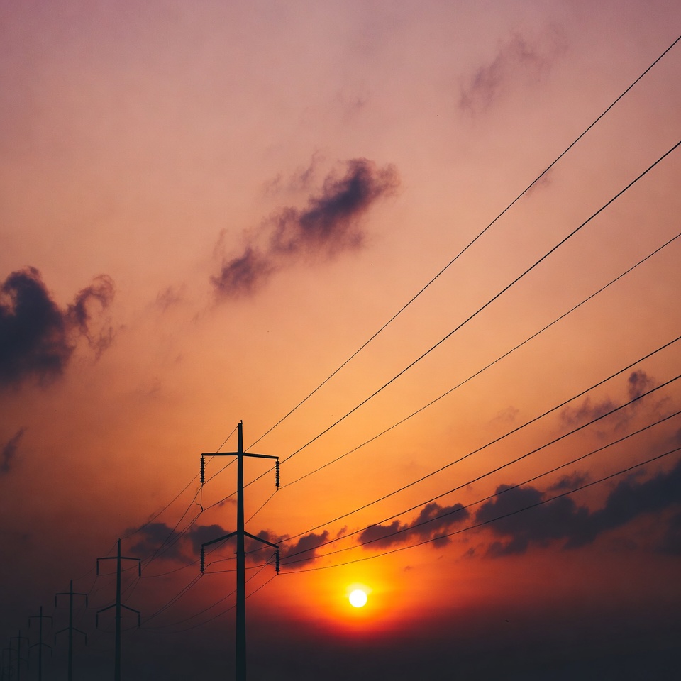 Power lines silhouetted against sunset Power lines silhouetted against sunset
