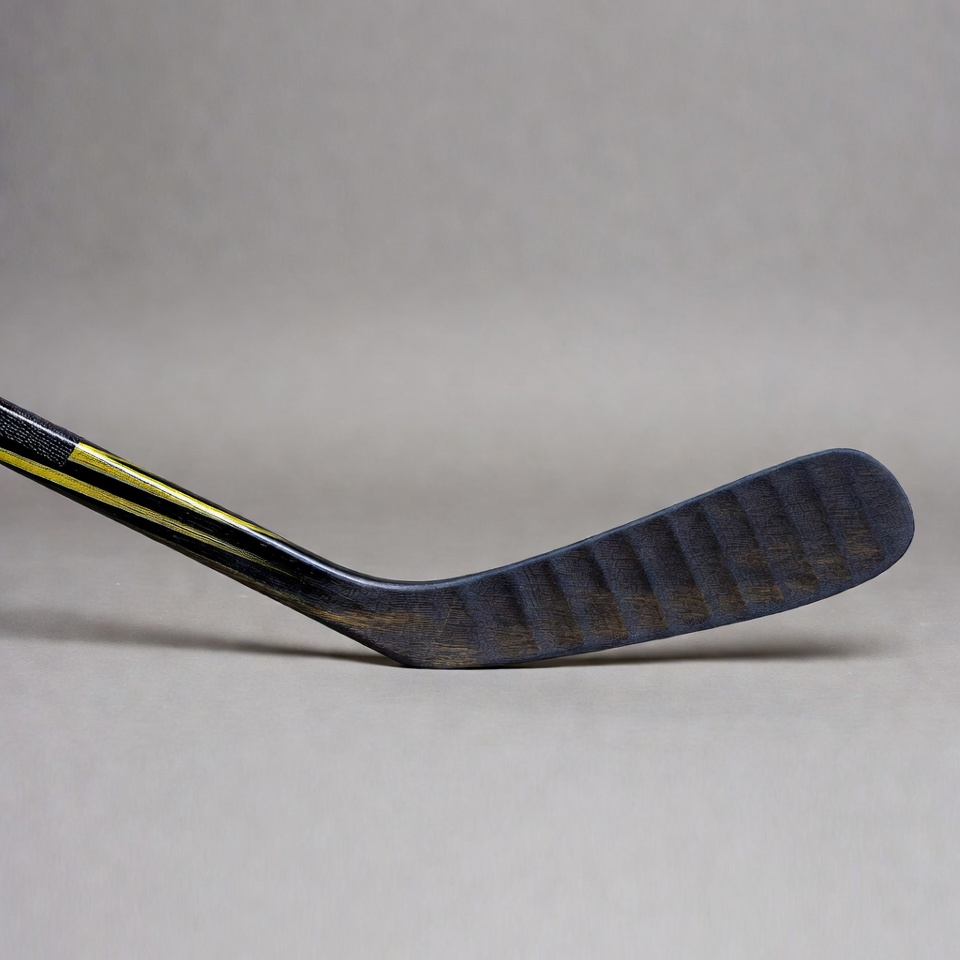 Black hockey stick with yellow stripe Black hockey stick with yellow stripe