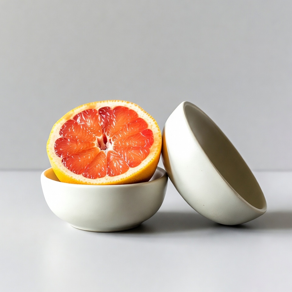 Sliced Grapefruit in White Bowls Sliced Grapefruit in White Bowls