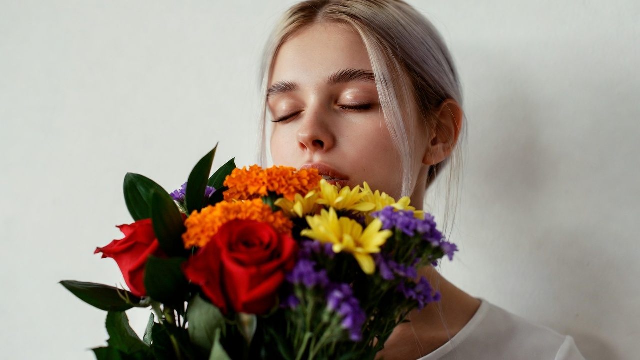 Woman smelling colorful bouquet Woman smelling colorful bouquet