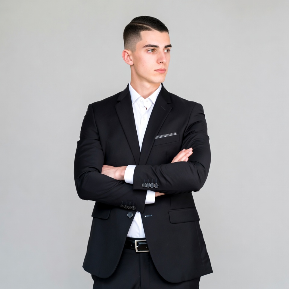 Young man in suit arms crossed Young man in suit arms crossed
