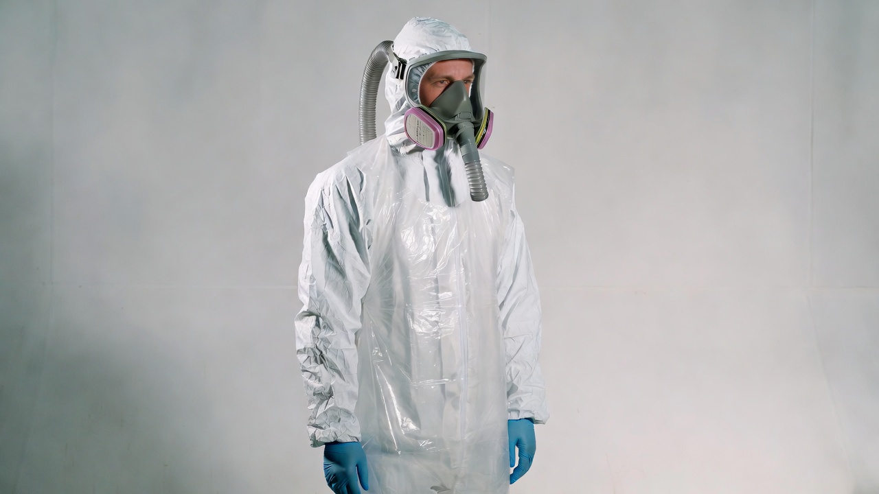 Man in white hazmat suit and respirator Man in white hazmat suit and respirator