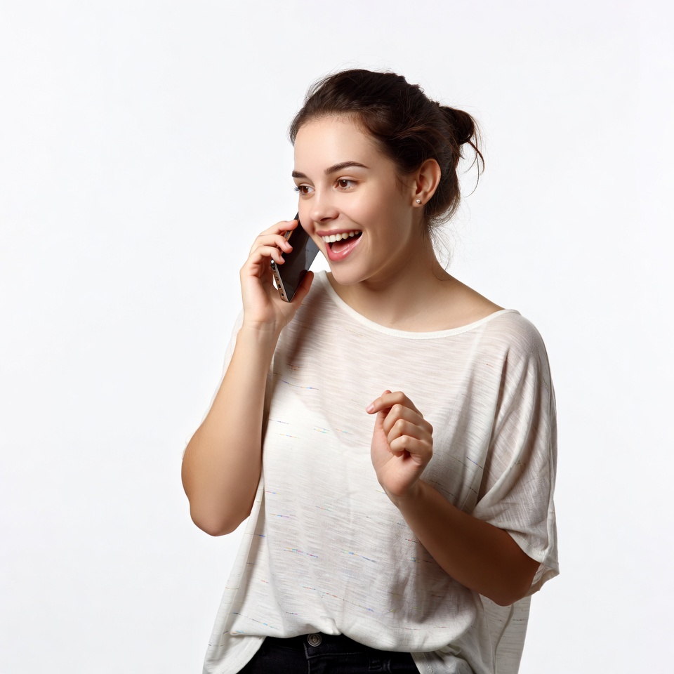Young woman laughing on phone call Young woman laughing on phone call