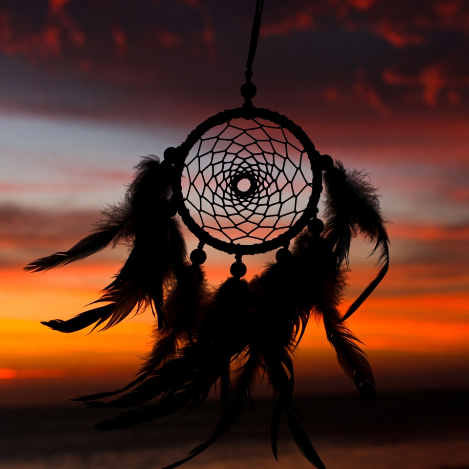 Dreamcatcher against sunset sky Dreamcatcher against sunset sky