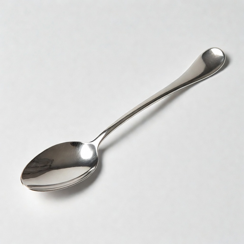 Shiny silver spoon on white background Shiny silver spoon on white background