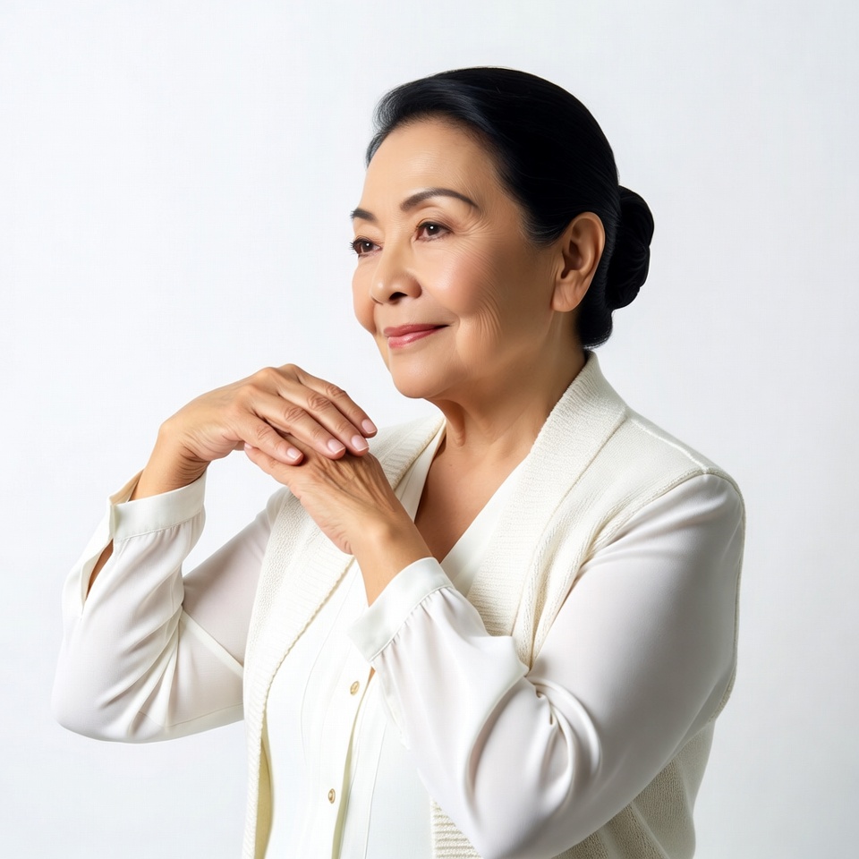 Asian woman with hands clasped smiling Asian woman with hands clasped smiling