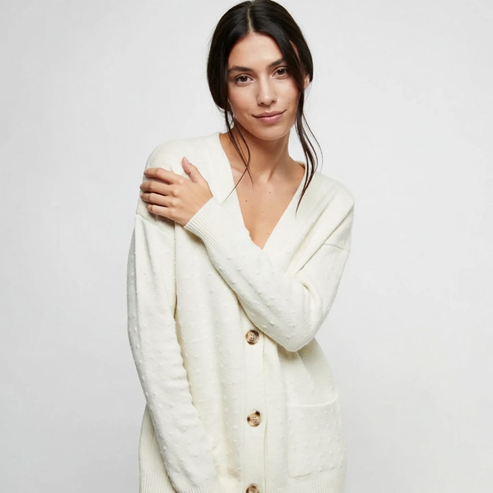 Woman in white cable knit cardigan Woman in white cable knit cardigan