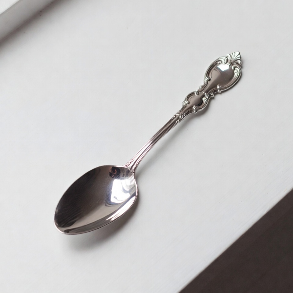 Silver ornate teaspoon on white background Silver ornate teaspoon on white background